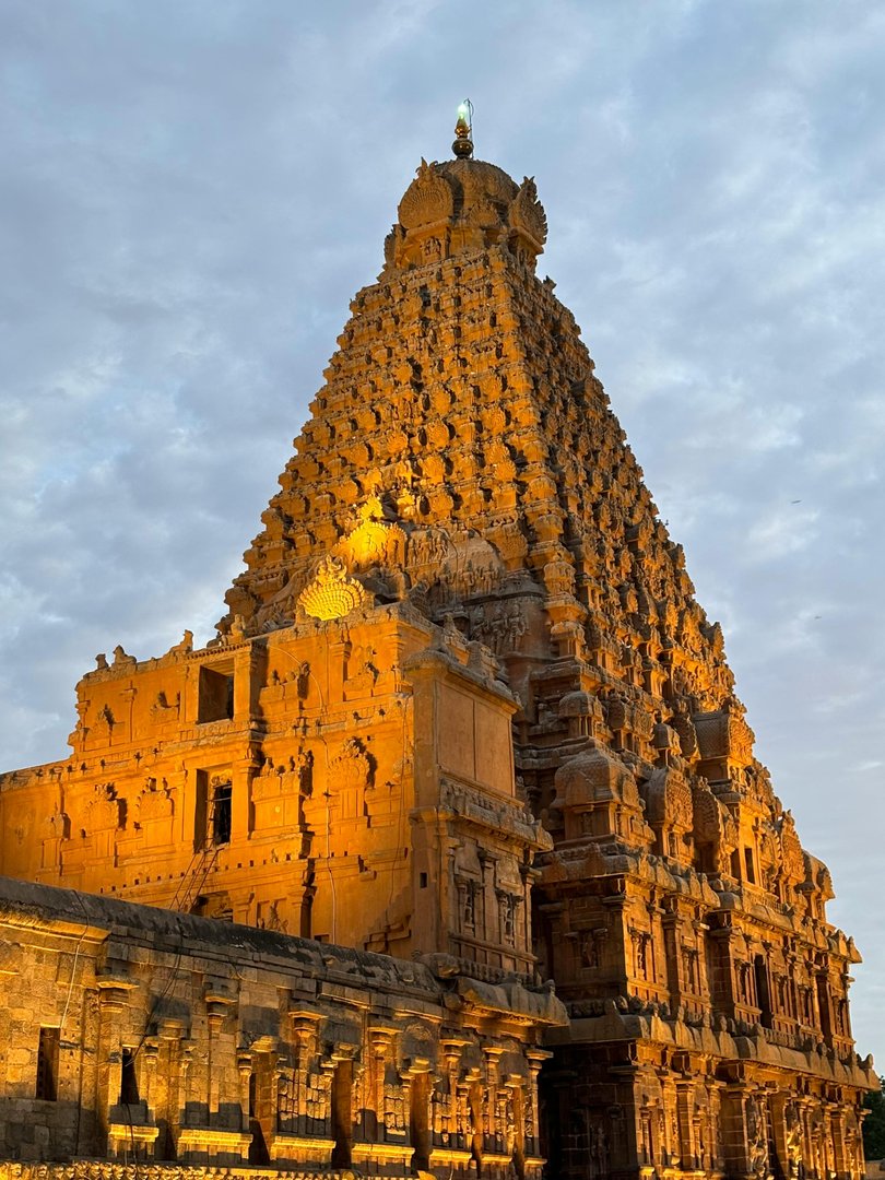 The vimana of Brihadisvara Temple illuminated at golden hour — the 13-storey tower carved entirely from a single piece of granite at the apex, with no mortar used in construction (Photo: Vasu Dev / Pexels)